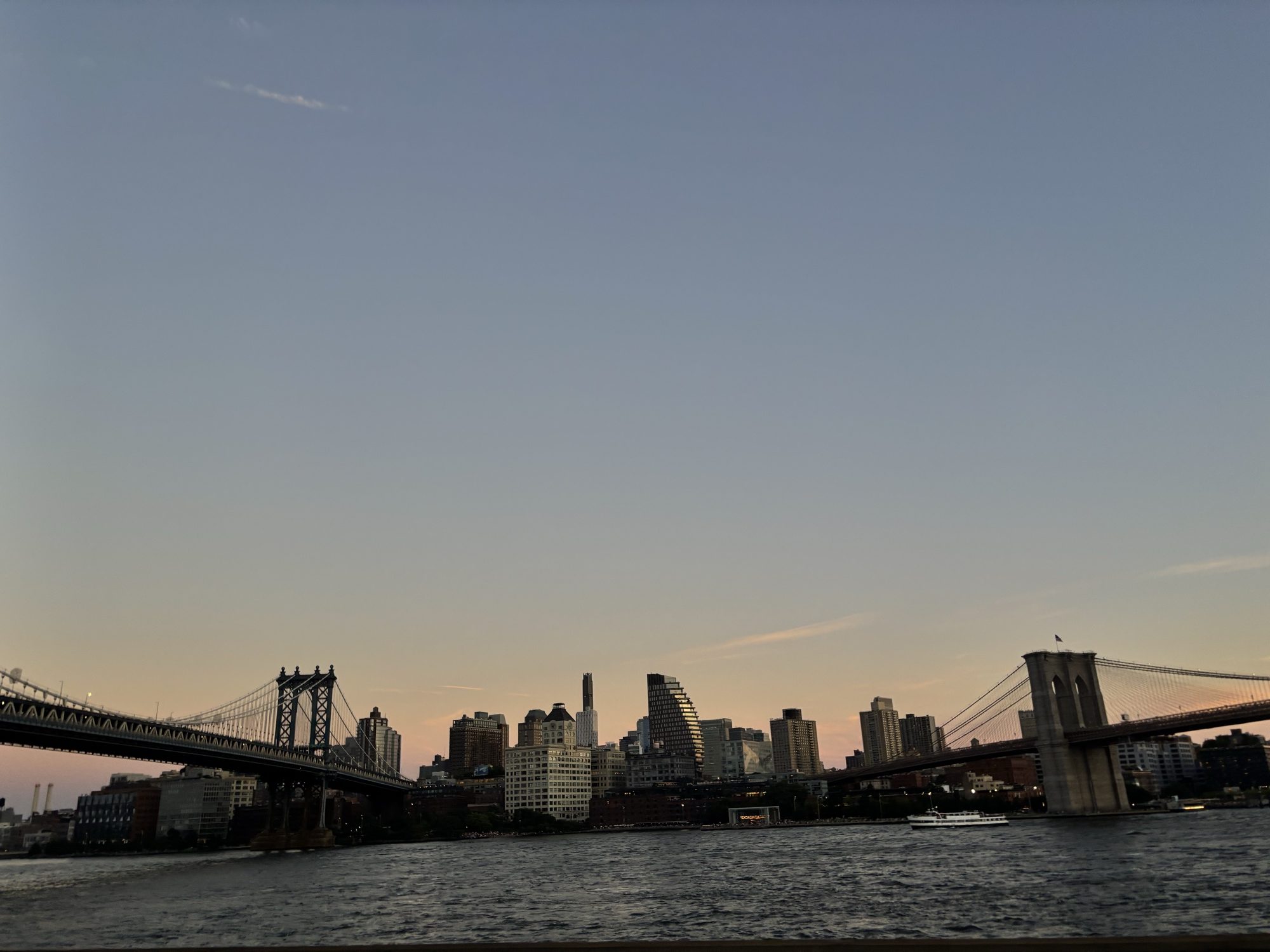 Manhattan and Brooklyn Bridges against the skyline at dusk