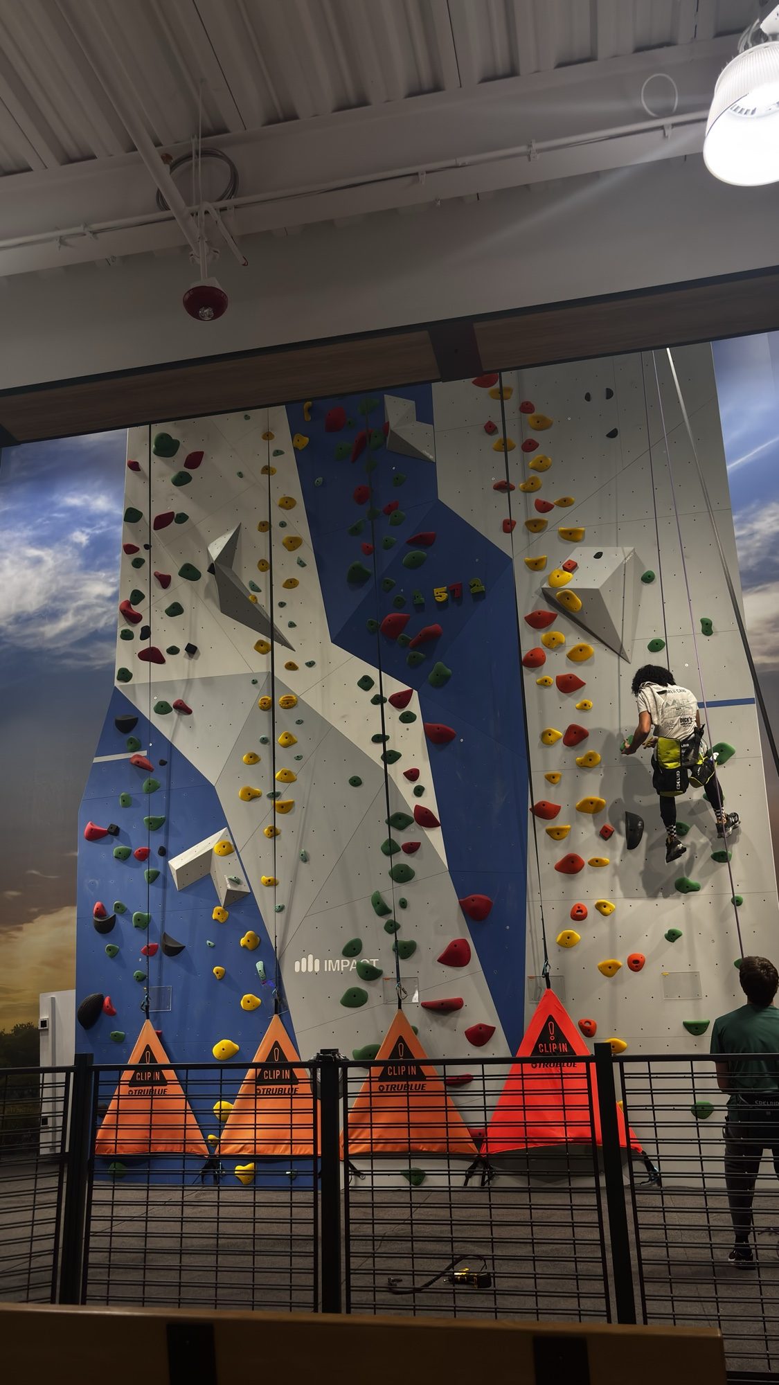 Indoor climbing wall with a climber partway up