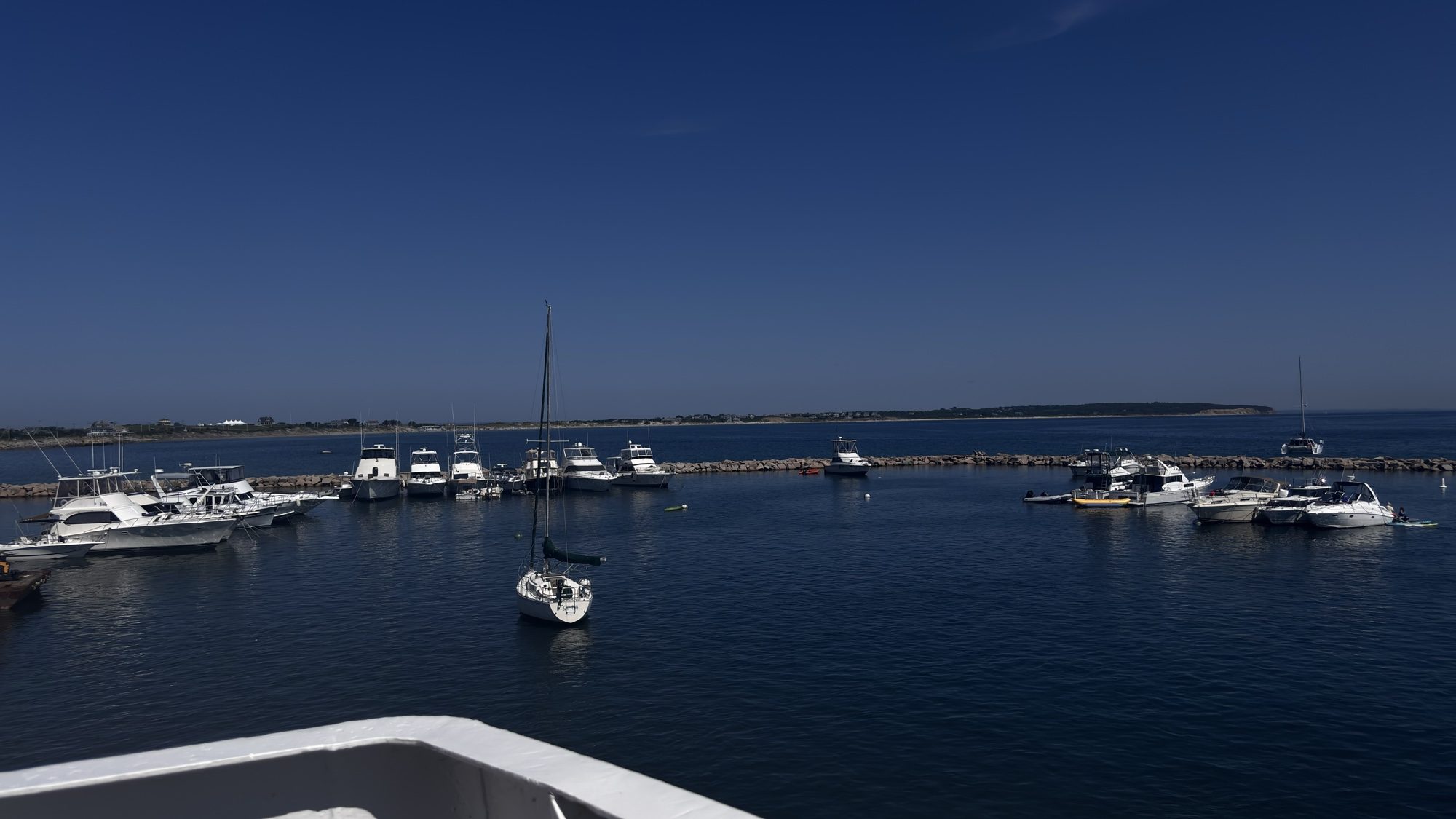 Boats moored in Block Island’s harbor, seen from the bow of a ferry