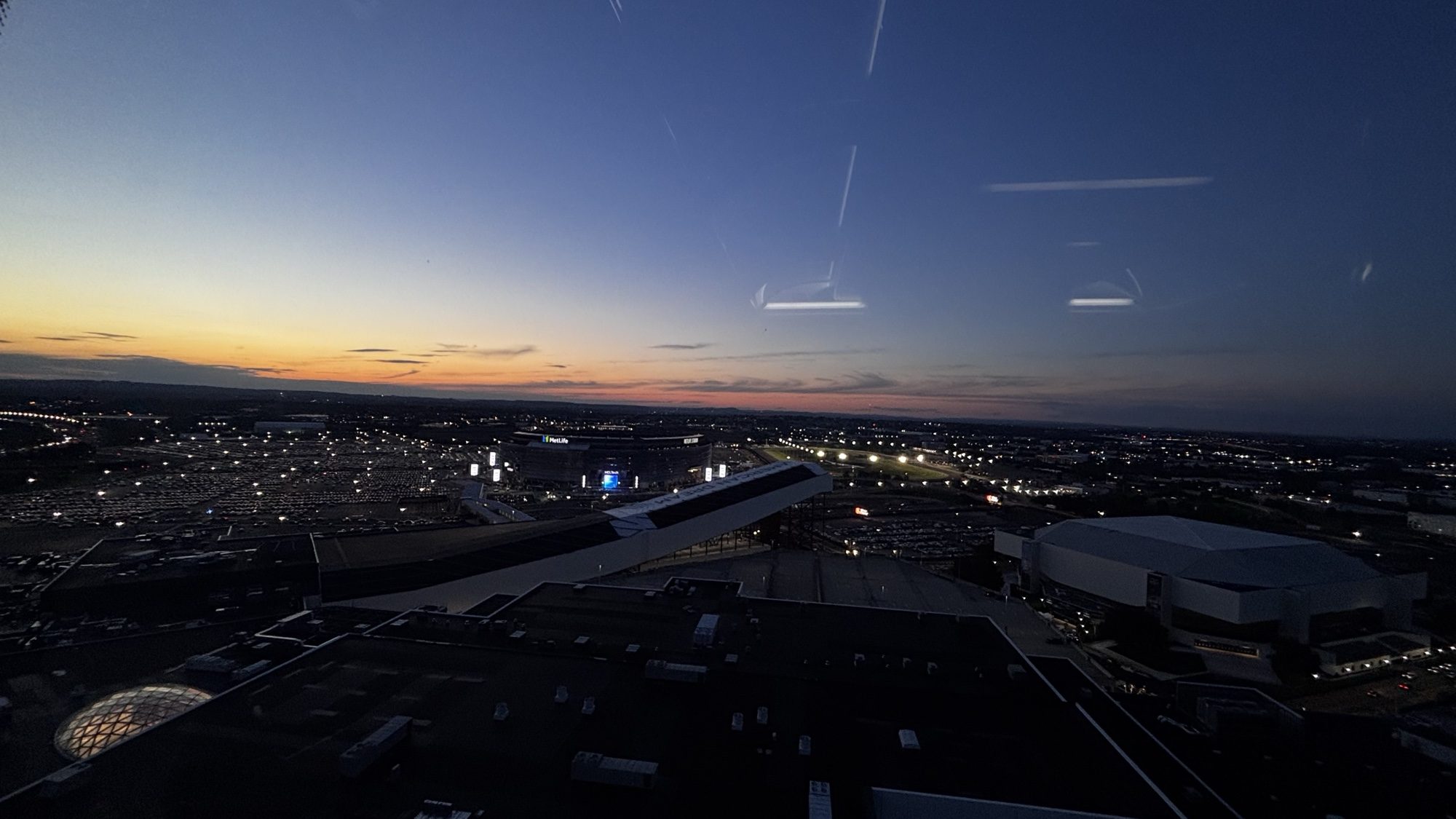 City lights at dusk, seen from above through a window