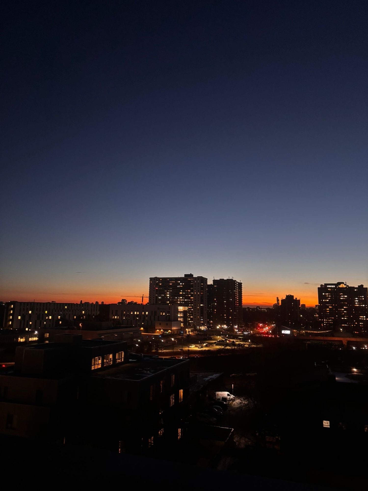 Dusk sky fading to orange over apartment buildings
